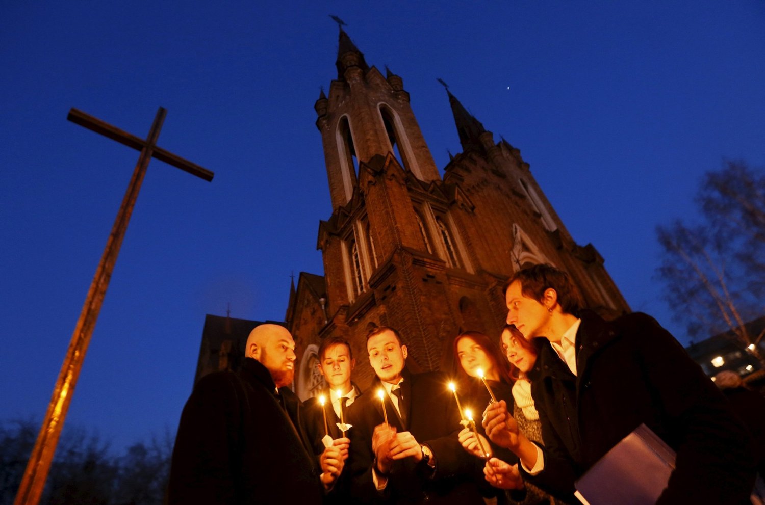 People light candles in front of a Catholic church during the Easter Vigil in the Siberian city of Krasnoyarsk, Russia, April 4, 2015.